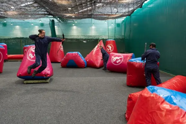 Archery tag players dodging