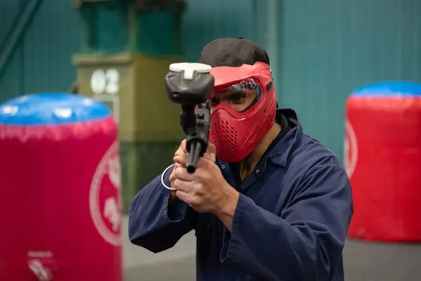 Paintball player in mask and overalls