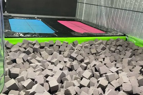 Foam pit with trampolines